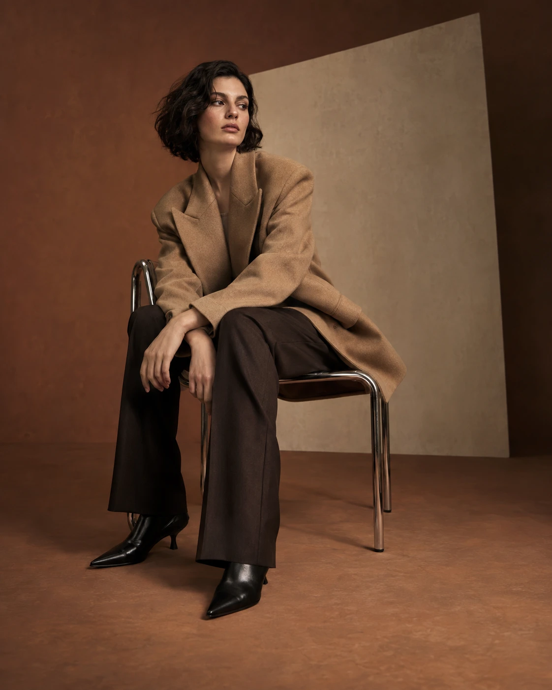 Original AI fashion study: camel tailoring and sculptural seating, shown in full